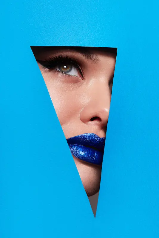 adult marketing woman looks through blue triangle